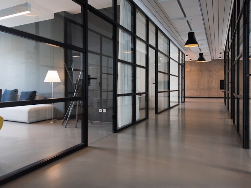 Modern office space with glass-walled meeting rooms — representative small commercial handyman context