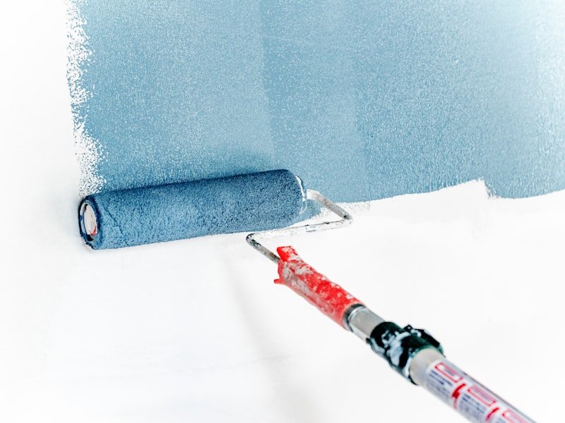 Paint roller applying a fresh coat to an interior wall
